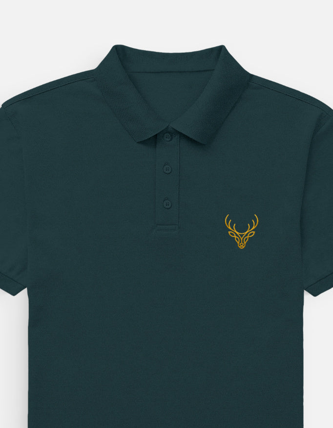 A dark teal-green short-sleeve polo shirt with a three-button placket and a small yellow embroidered deer head logo on the left chest, shown against a light gray background.