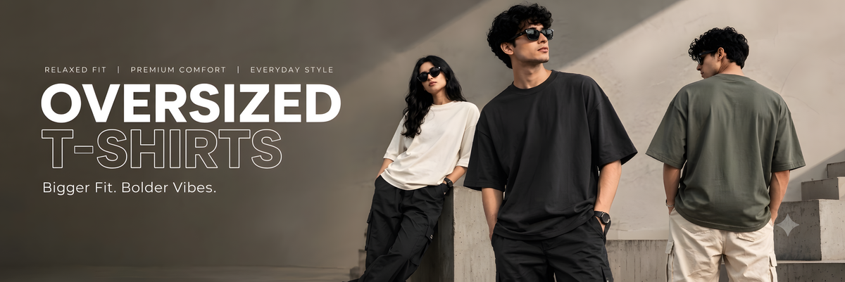 Promotional banner for oversized T-shirts showing three models wearing different colored shirts in an outdoor setting with concrete steps and shadows. Large text on the left reads 'OVERSIZED T-SHIRTS' with smaller descriptive copy.